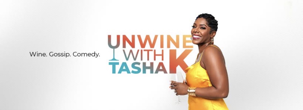 Tasha K of Unwine With Tasha K holding a glass of wine